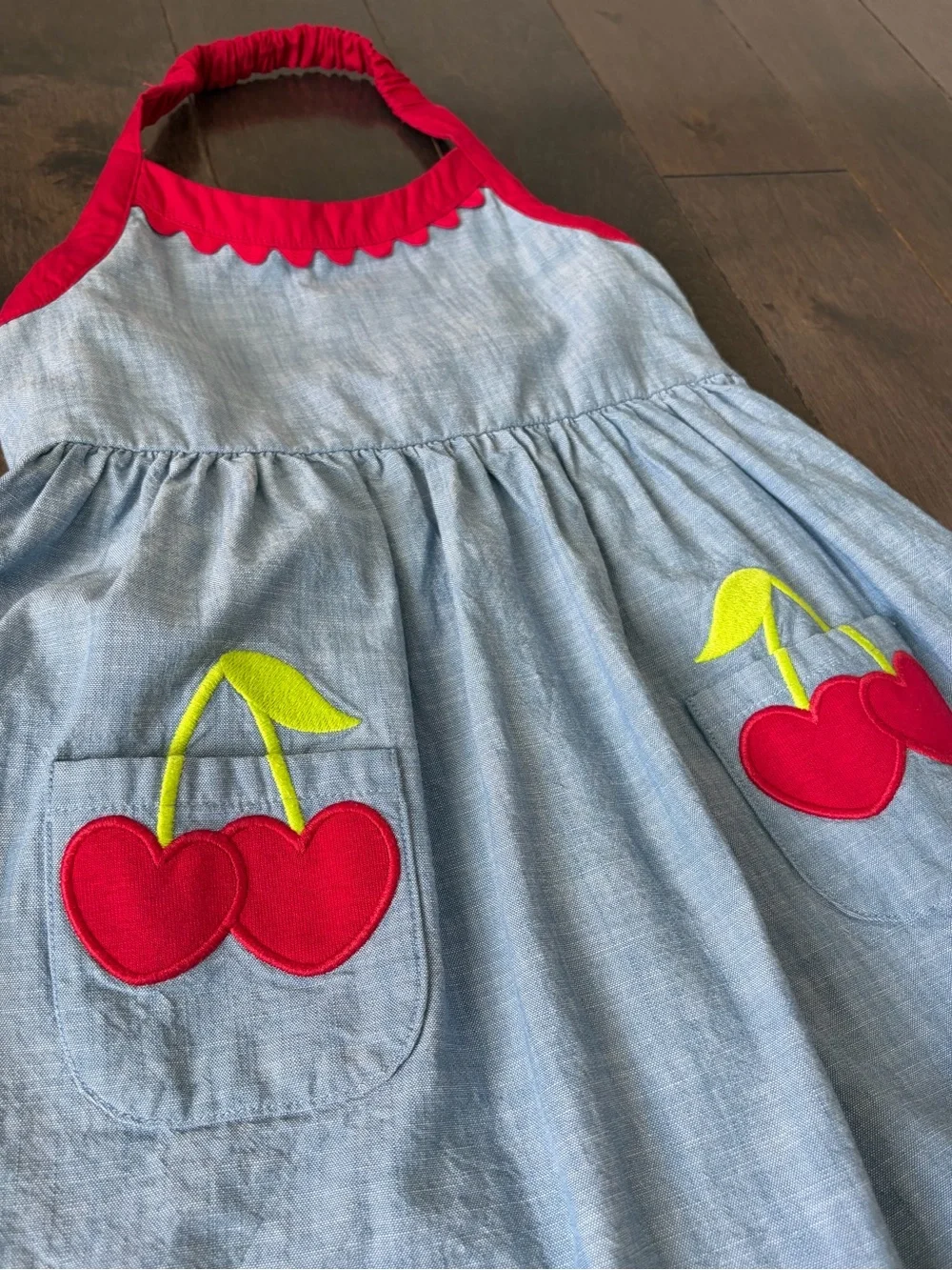 Gymboree Toddler Girl Denim Halter Dress with red trim and cherry pockets .